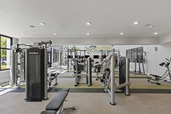 A gym with weights and cardio equipment in a building